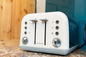 a white toaster sitting on top of a counter at St Johns House in Leeds