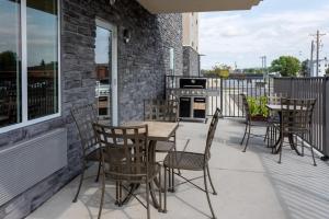 a patio with a table and chairs on a balcony at Candlewood Suites - Rochester Mayo Clinic Area in Rochester