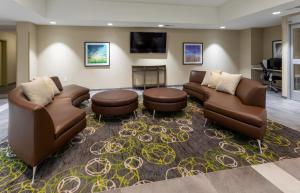 a living room with two couches and a fireplace at Candlewood Suites - Rochester Mayo Clinic Area in Rochester