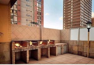a balcony with a fire pit on a building at The Oceanic in Durban