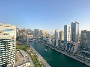 a view of a city with a river and buildings at Dorra Bay Tower Dubai Marina - AL Maraseem in Dubai