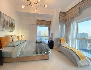 a bedroom with a bed and a large window at Dorra Bay Tower Dubai Marina - AL Maraseem in Dubai