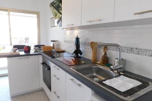a kitchen with a sink and a counter top at Spacious T2 "Jardin du Pont du Lys" with pool and parking in Antibes