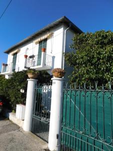 a white house with a gate with potted plants on it at "T3 ground floor of the villa "Les muguets" 3 minutes from the beach" in Vallauris