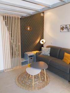 a living room with a couch and a table at T1 "Santa Luccia" with air conditioning in Saint-Laurent-du-Var