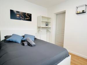 a bedroom with a bed with two pillows on it at Le Musée 3, cocooning 2 pièces in Bergerac