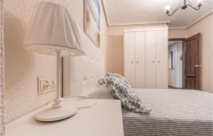 A bed or beds in a room at Stunning Apartment In Gijón With Wifi