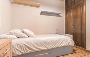 A bed or beds in a room at Stunning Apartment In Gijón With Wifi