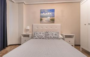 A bed or beds in a room at Stunning Apartment In Gijón With Wifi