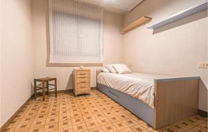 A bed or beds in a room at Stunning Apartment In Gijón With Wifi