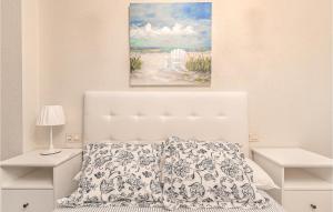 A bed or beds in a room at Stunning Apartment In Gijón With Wifi