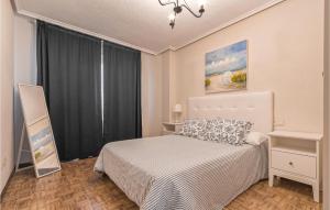 A bed or beds in a room at Stunning Apartment In Gijón With Wifi