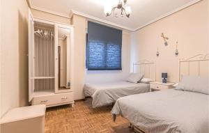 A bed or beds in a room at Stunning Apartment In Gijón With Wifi