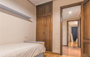 A bed or beds in a room at Stunning Apartment In Gijón With Wifi