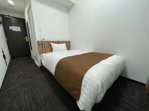 Postel nebo postele na pokoji v ubytování Ueno Urban Hotel Annex