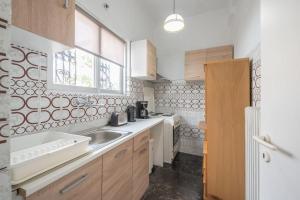 a kitchen with a sink and a counter top at Penthouse with urban and partial sea view! in Athens