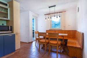a kitchen and dining room with a table and chairs at Iglica Apartments - First Floor in Bohinjska Bela