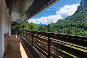 a balcony with a bench and a view of the mountains at Iglica Apartments - First Floor in Bohinjska Bela