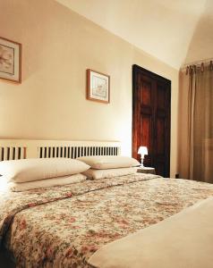 a bedroom with a large bed with pillows on it at Pane&Burro in Vercelli