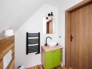 a bathroom with a green cabinet and a sink at Dom Pod Wierzbami, zniżki na termy in Białka Tatrzańska
