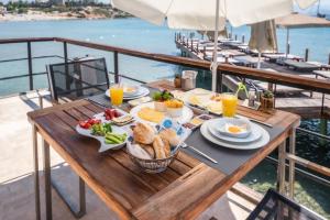 a table with breakfast food on a yacht at Yacht Club in Didim
