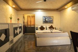 a bedroom with two beds in a room at Seasons Suites JP Nagar in Bangalore
