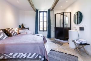 a bedroom with a bed and a mirror at B&B du Couvent, vue château in Giroussens