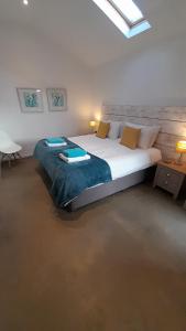 a bedroom with a large bed in a room at Umber, Gallery Cottages, Devon in West Putford