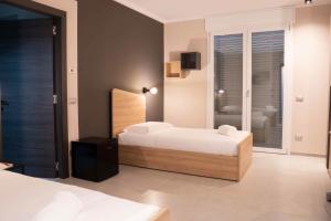 a bedroom with two beds and a television in it at Terranova49 in Novara