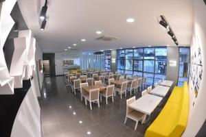 a dining room with tables and chairs and windows at R S CİTY HoTEL in Samsun