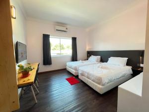 Postel nebo postele na pokoji v ubytování MG Kuah Langkawi