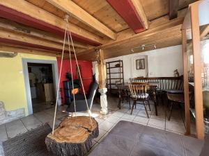 a living room with a wooden ceiling and a table at Ferienwohnung "An der schönen Bahra" in Bahra