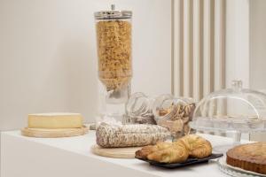 a table with bread and other food items on it at Hotel Aurora in Pavia