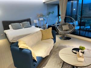a bedroom with a bed and a couch and a table at 暮嶼 twilight island in Toucheng