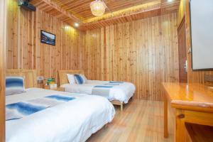 Postel nebo postele na pokoji v ubytování Nanjing Tulou Xinyuan HomeStay