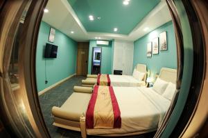 Zimmer mit 2 Betten und einem Spiegel in der Unterkunft LAHONA HOTEL in La Gi