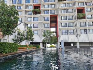 a swimming pool in front of a building at Avenpeak Homestay Tamarind Wifi, Netflix, Iron, Filter, TV, Self Checkin in Cyberjaya