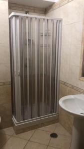 een douchecabine in een badkamer met een wastafel bij Monolocale in Via Poerio in Catanzaro
