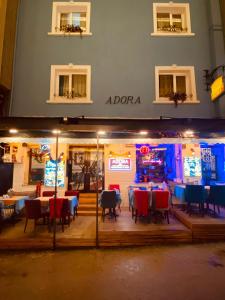 a restaurant with tables and chairs and a video game at Adora Hotel Cafe & Restaurant in Istanbul