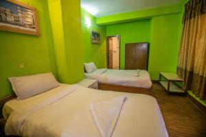 Postel nebo postele na pokoji v ubytování Hotel Pomelo House Inn