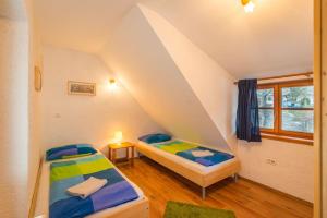 two beds in a room with an attic at Mala Vas Chalet in Bovec