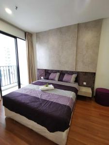 - une chambre avec un grand lit et des draps violets dans l'établissement LAVENDER Suite @ I-City, à Shah Alam