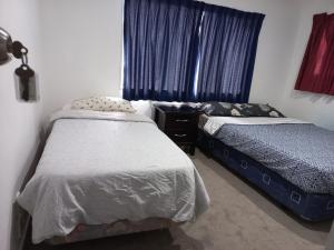 Postel nebo postele na pokoji v ubytování Papamoa Holiday Home