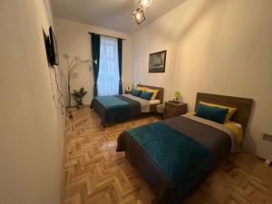 a room with two beds and a window in it at Le Royal Suites Sarajevo - City Center in Sarajevo