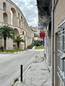 an empty street next to a building with a street sign at Kamares View in Kavala