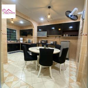a large kitchen with a table and chairs at MAWAR HOMESTAY KUCHING in Kuching