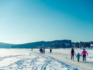 a group of people walking on a snow covered beach at Landal Marina Lipno in Lipno nad Vltavou