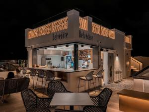 a restaurant with a bar with chairs and tables at Boutique Hotel Cordial Plaza Mayor de Santa Ana in Las Palmas de Gran Canaria
