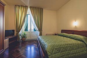 מיטה או מיטות בחדר ב-Albergo Ristorante Pasqui