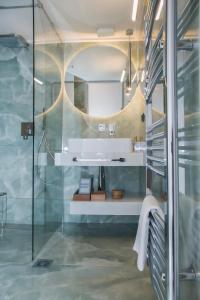 a bathroom with a glass shower with a sink at Luxury Premium Suite #4 in Chalkida